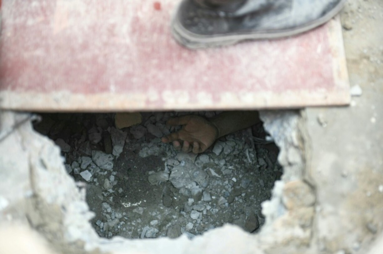 The hand of a victim trapped in the rubble in Mandalay after a devastating earthquake hit Myanmar