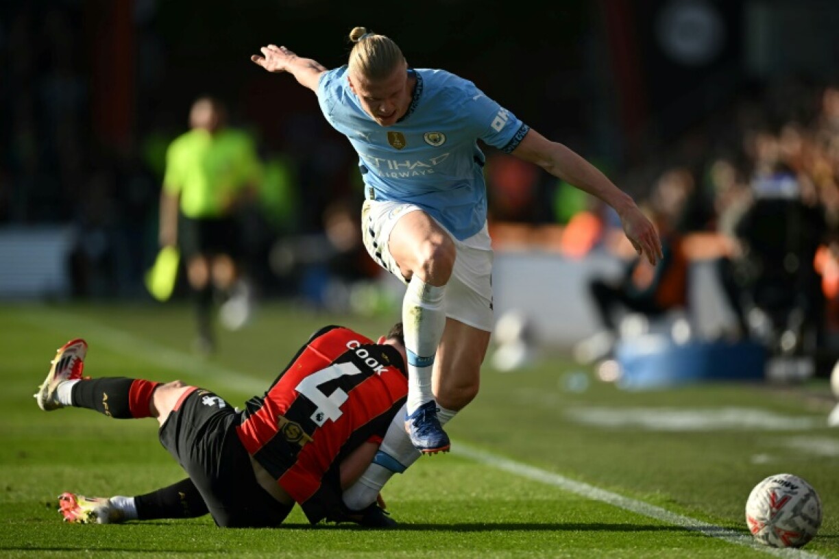 Injury: Erling Haaland is hurt in this challenge with Bournemouth's Lewis Cook on Sunday