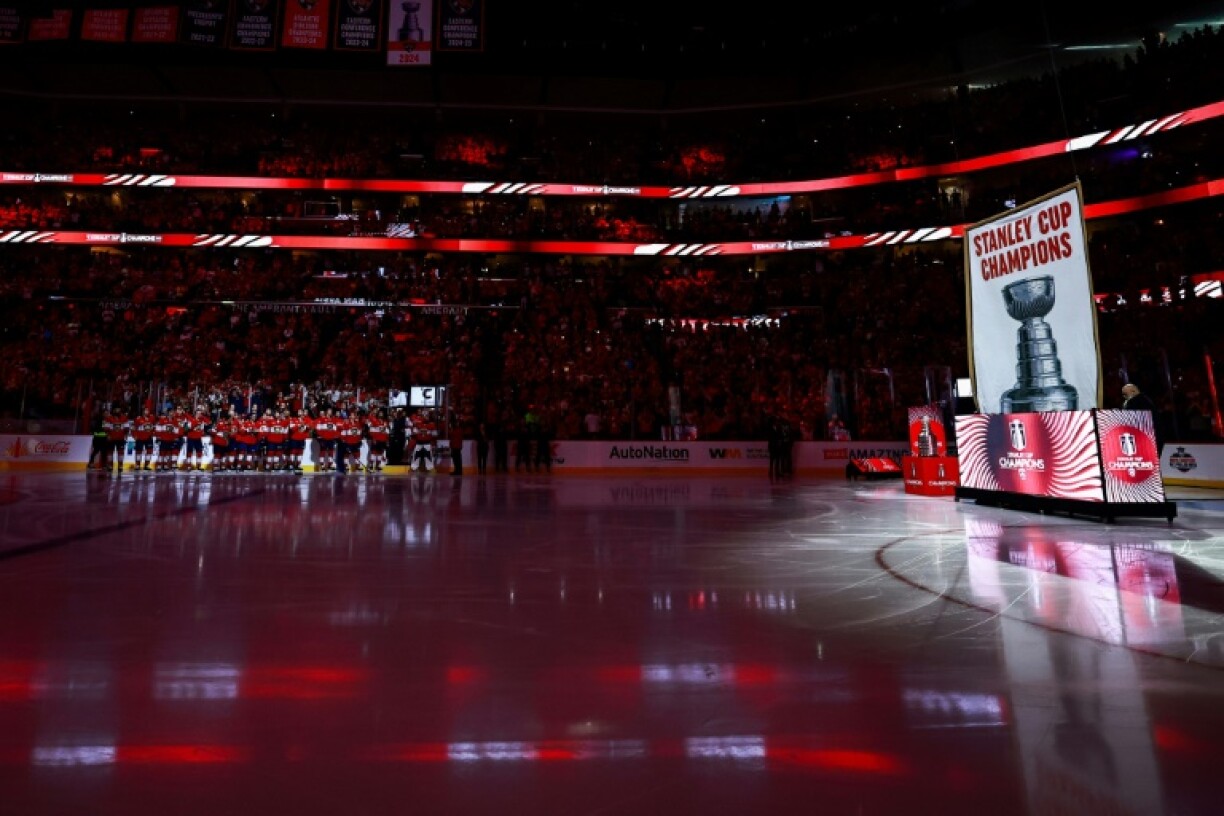 The Florida Panthers watch as their 2025 Stanley Cup championship banner is raised ahead of their victory over visiting Chicago in the 2025-26 NHL season opener