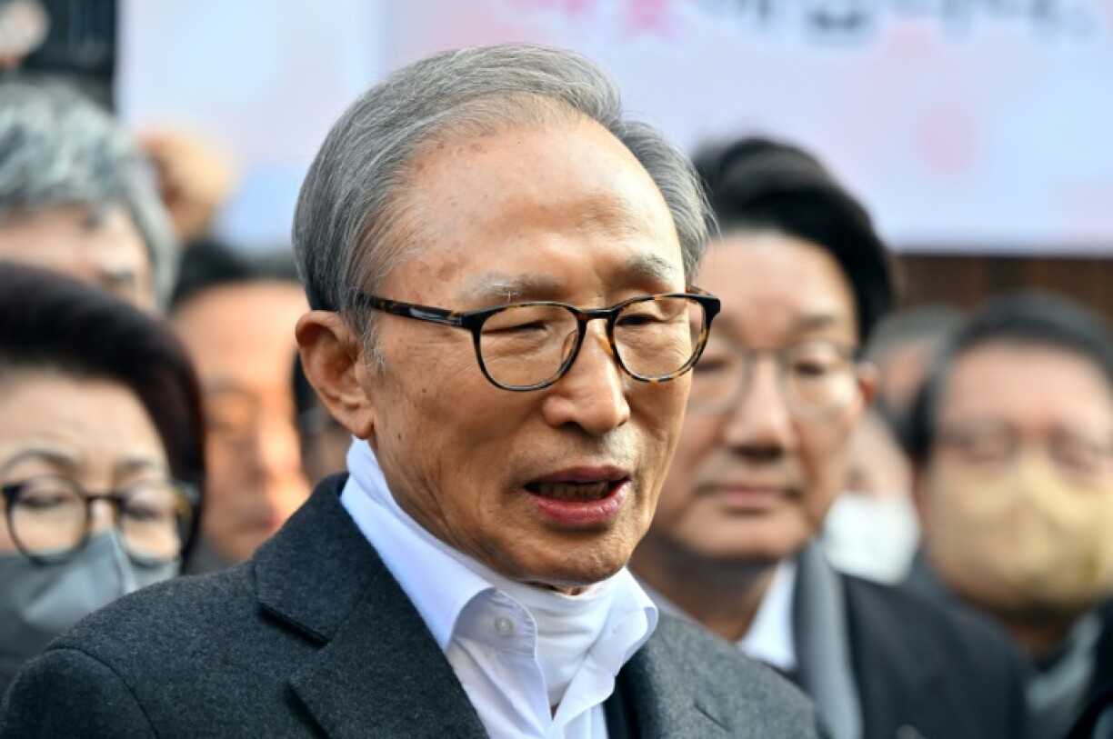 Former South Korean president Lee Myung-bak speaks to the media as he arrives at his home in Seoul on December 30, 2022, after he received a presidential pardon cutting short his 17-year sentence on corruption charges