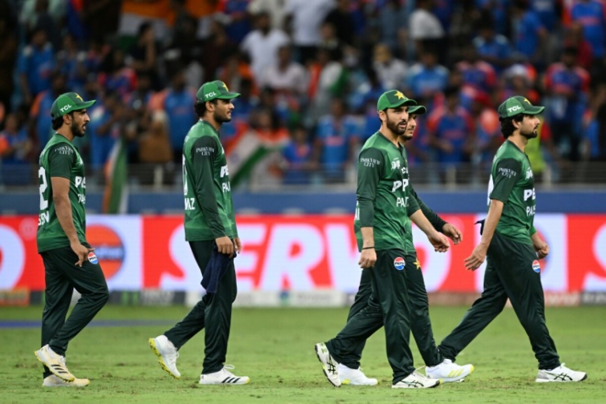 Pakistan's players walk back to the pavilion after losing to India