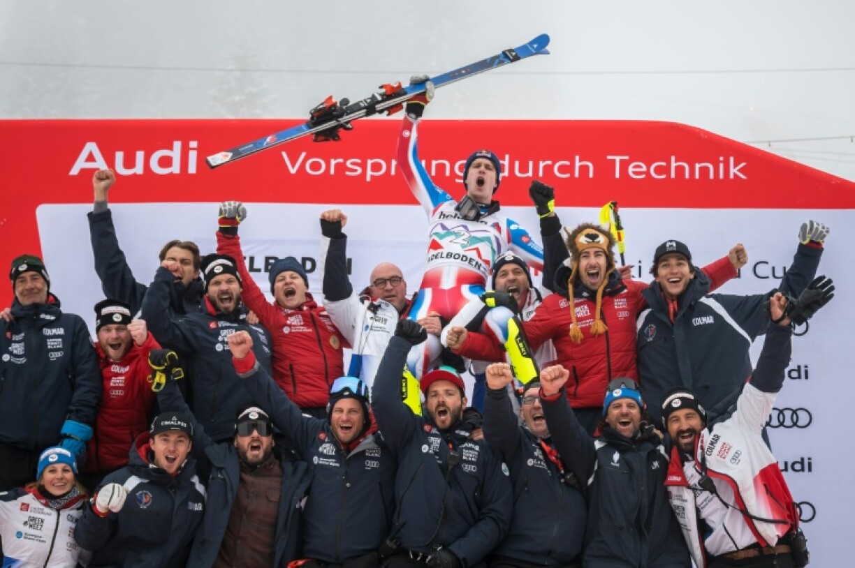 France's Clement Noel (C) celebrates with team members after winning the men's slalom in Adelboden
