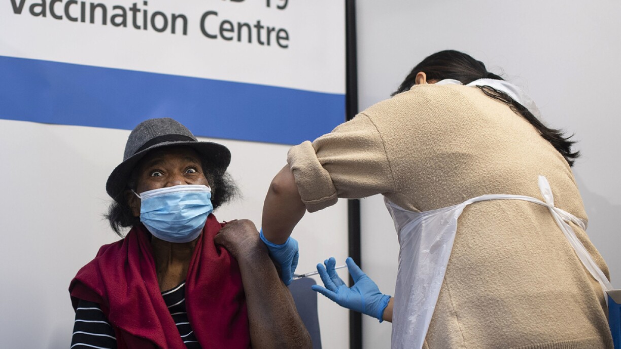 Lorna Lucas, 81, reacts as she receives the first of two Pfizer/BioNTech Covid-19 vaccine jabs, at Guy's Hospital in London on December 8, 2020. Britain on December 8 hailed a turning point in the fight against the coronavirus pandemic, as it begins the biggest vaccination programme in the country's history with a new Covid-19 jab.