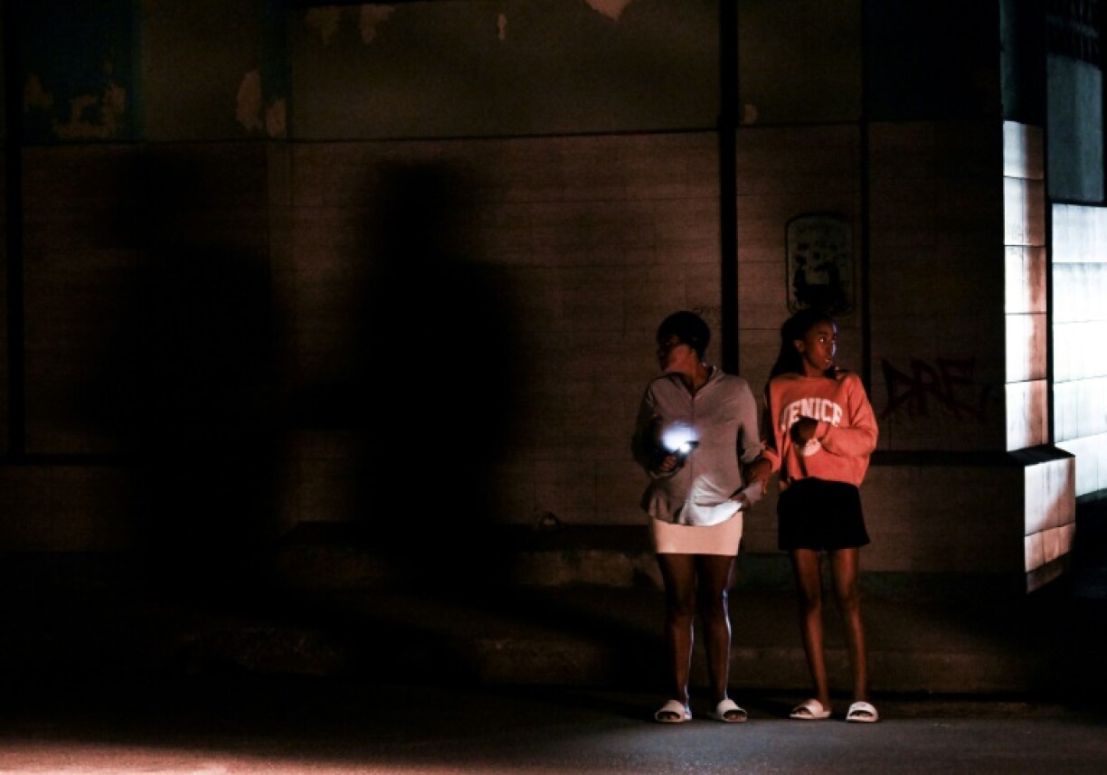 Cubans stand on a corner during a general blackout in Havana on March 14, 2025