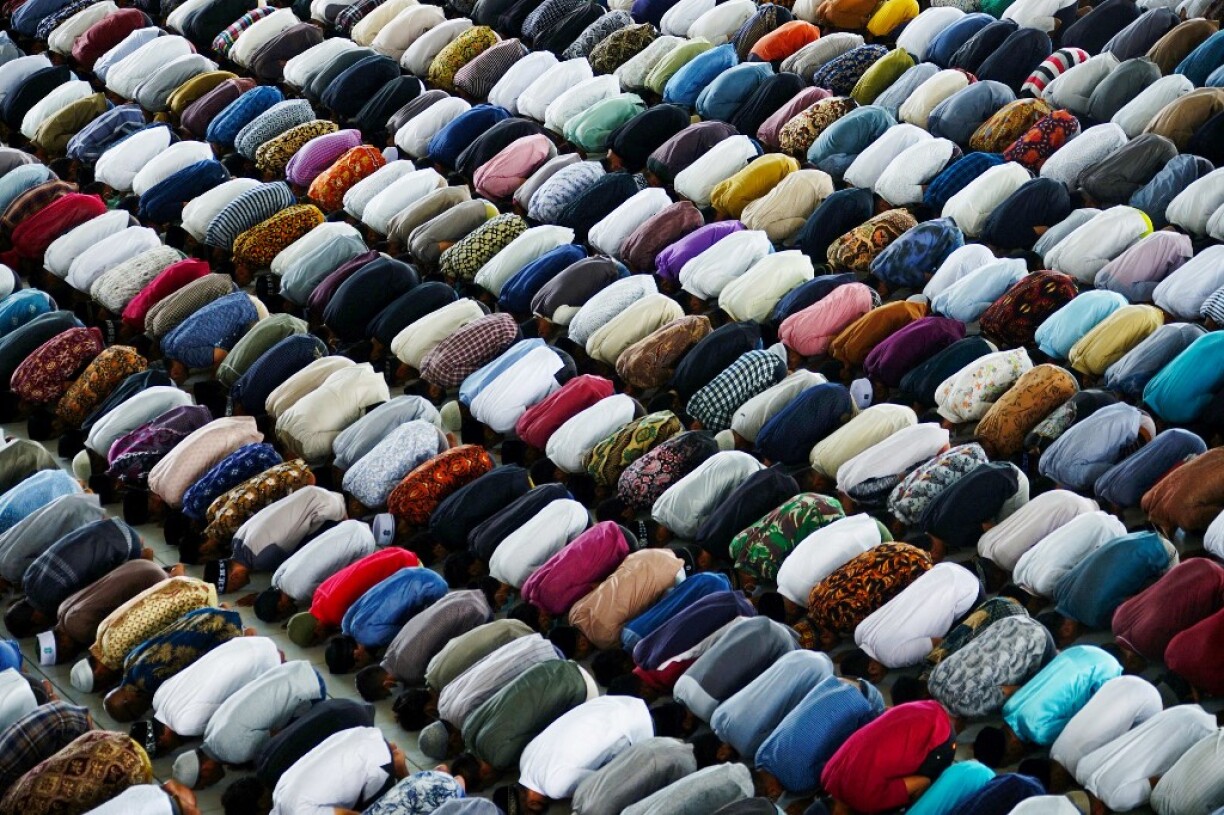 Muslims pack into a crowded mosque to carry out Friday prayers in Lhokseumawe, Aceh, on July 9, 2021, despite the recent implementation of nationwide emergency restrictions to prevent the spread of the COVID-19 coronavirus.