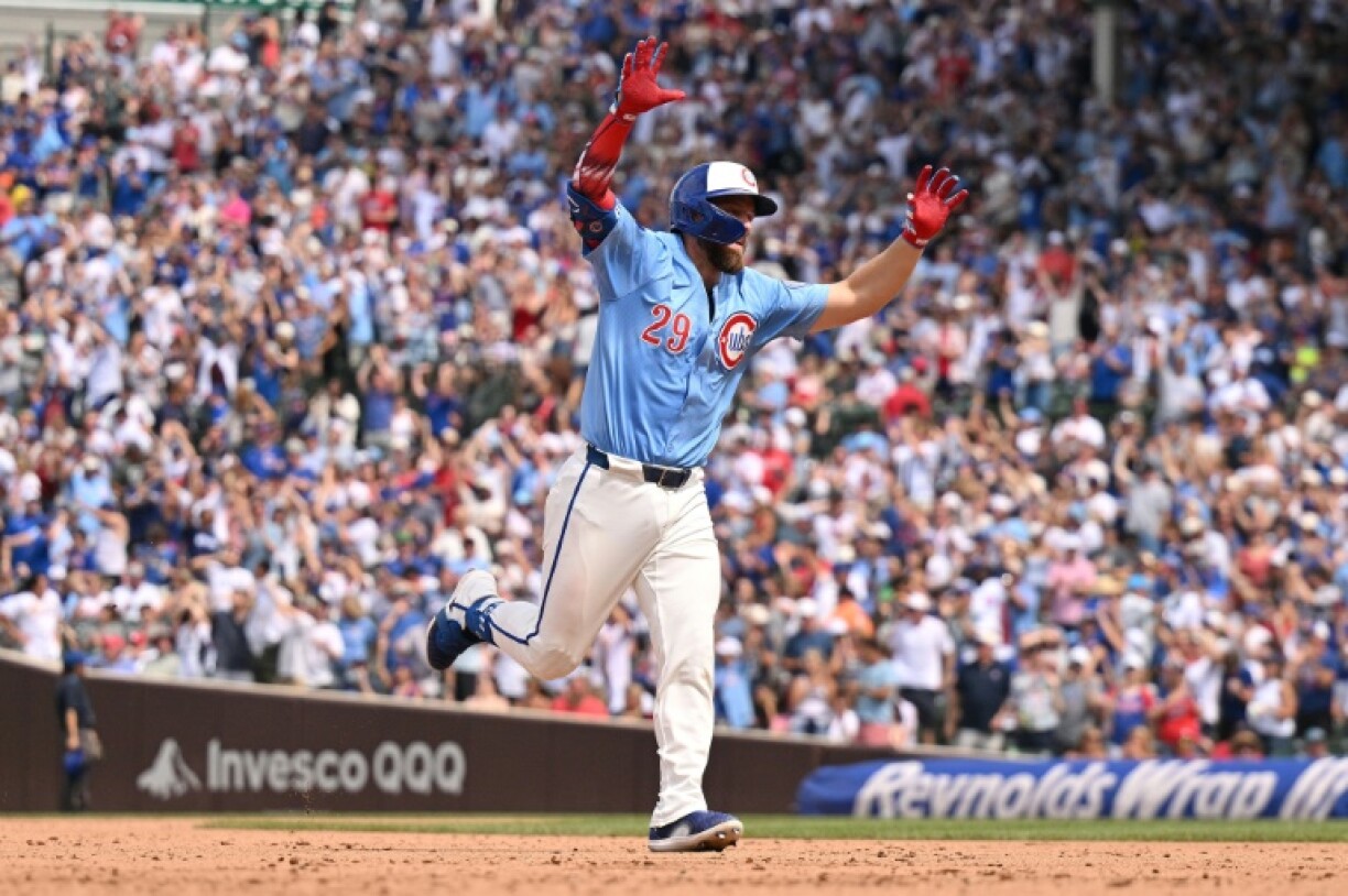 Michael Busch of the Chicago Cubs runs the bases while celebrating his third home run of the day in an 11-3 MLB victory over St. Louis