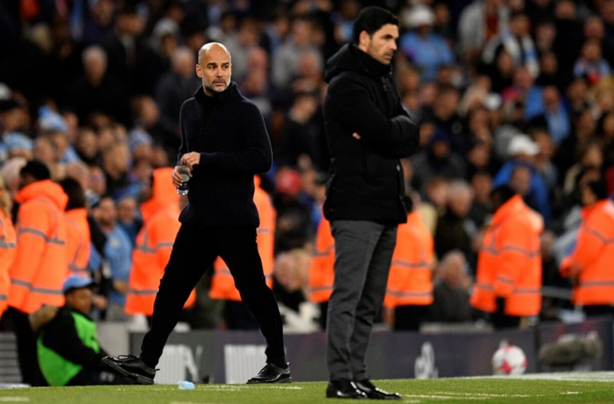 Manchester City manager Pep Guardiola (L) and Arsenal boss Mikel Arteta (R)