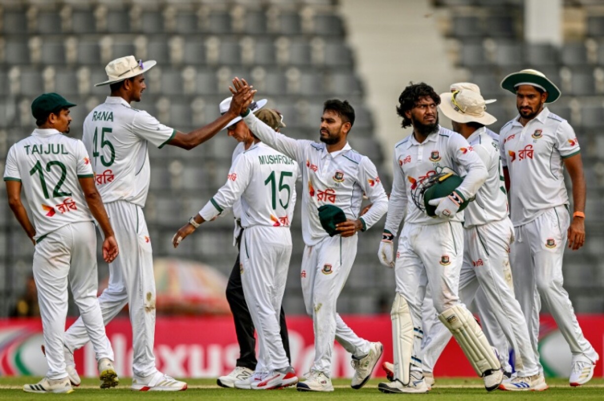 Bangladesh’s Mehidy Hasan Miraz (C) celebrates after taking the wicket of Zimbabwe’s Victor Nyauchi