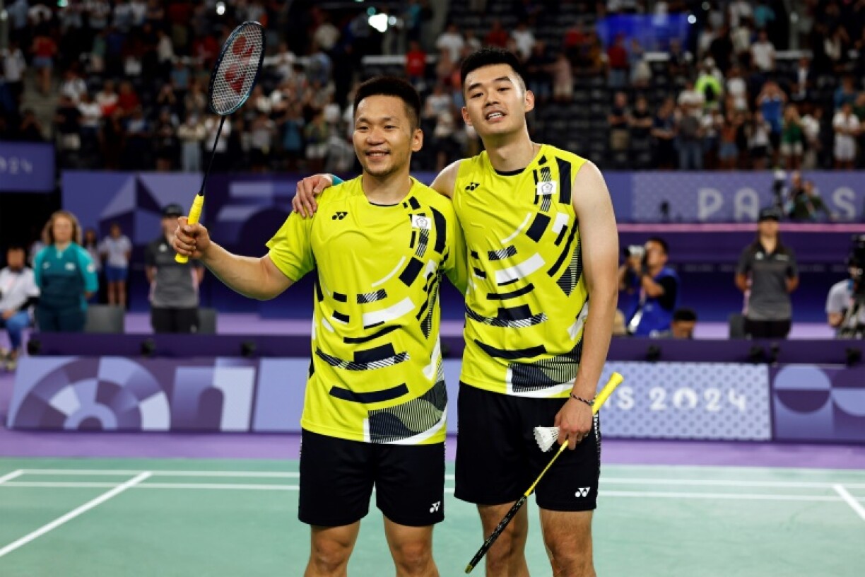 Taiwan's Wang Chi-lin and Lee Yang celebrate winning the men's doubles badminton semi-final match during the Paris 2024 Olympic Games
