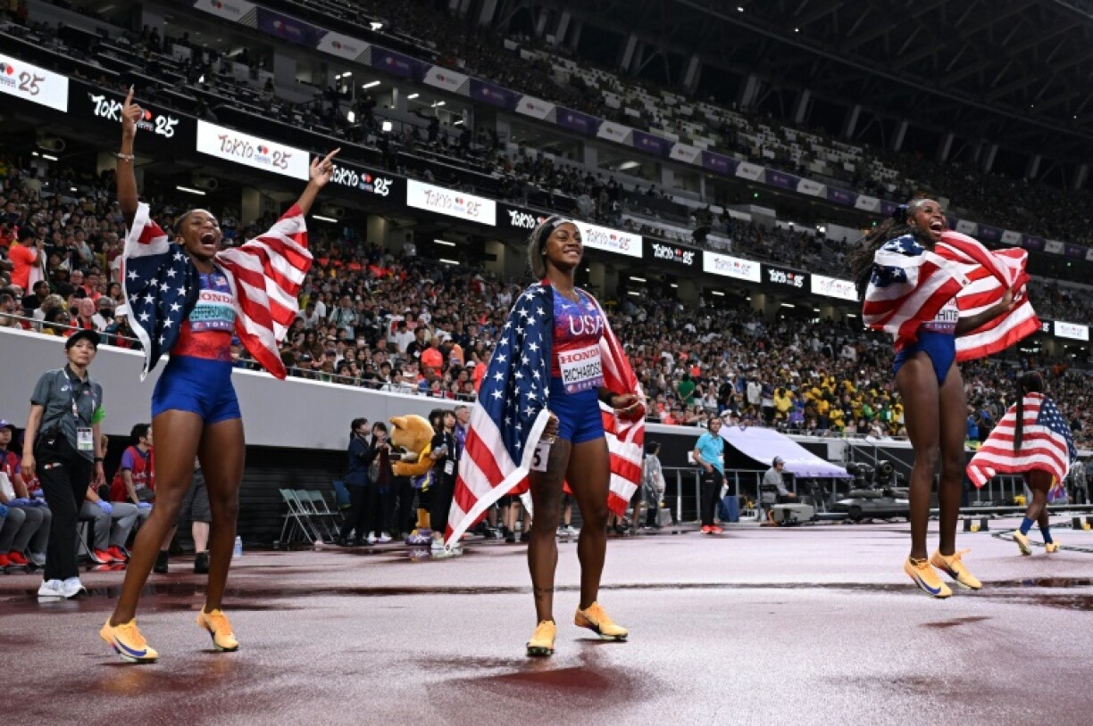 Melissa Jefferson-Wooden (L) celebrates with US relay teammates Sha'Carri Richardson and Kayla White after winning the gold at the world championships