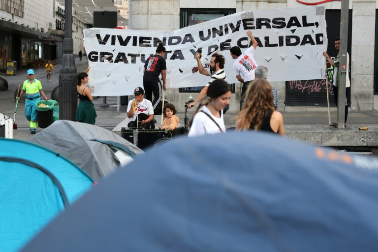 Housing activists install a banner in Madrid's central Puerta del Sol square