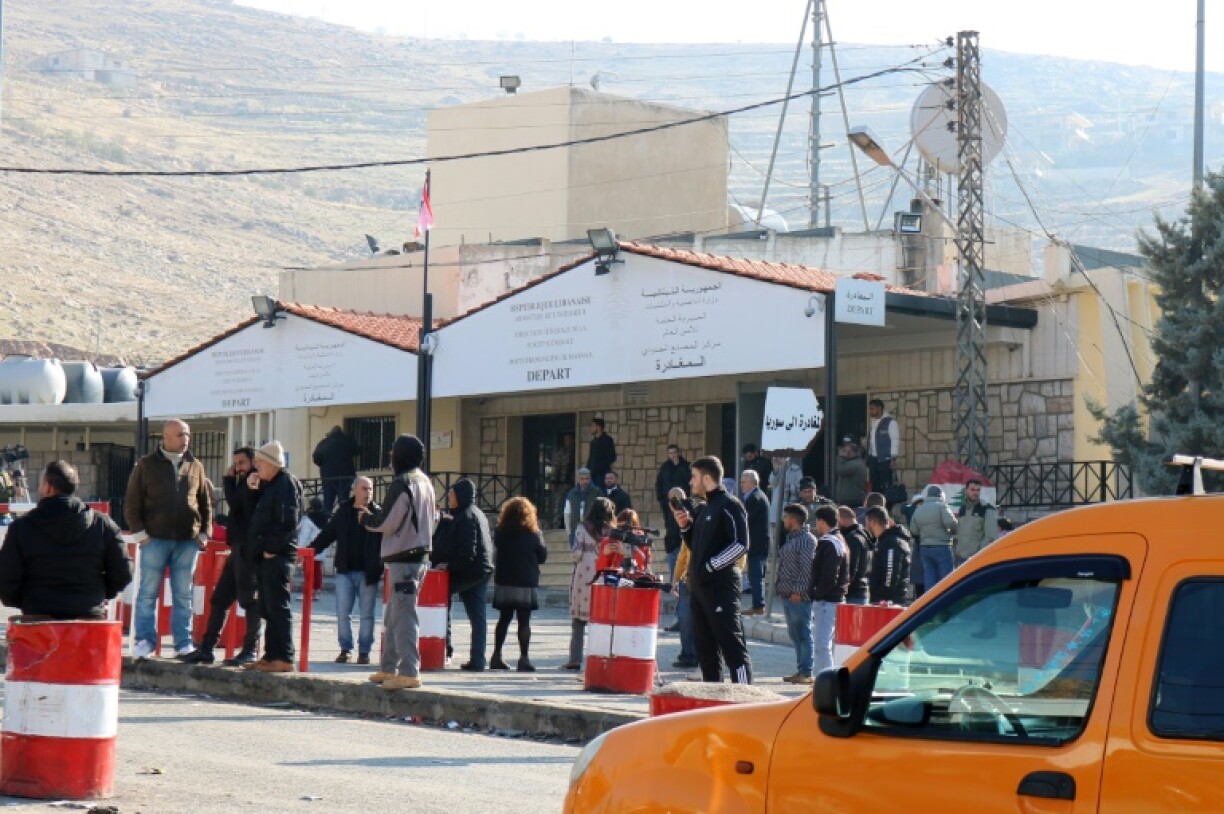 Travellers wait on the Lebanese side of the Masnaa border crossing after Syria imposed new restrictions on the entry of Lebanese citizens.