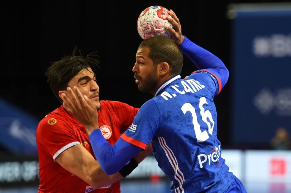 Le demi-centre français Nicolas Claire (d) s'apprête à tirer lors du match qualificatif pour les Jeux olympiques de Tokyo contre la Tunisie, à Pérols, le 13 mars 2021