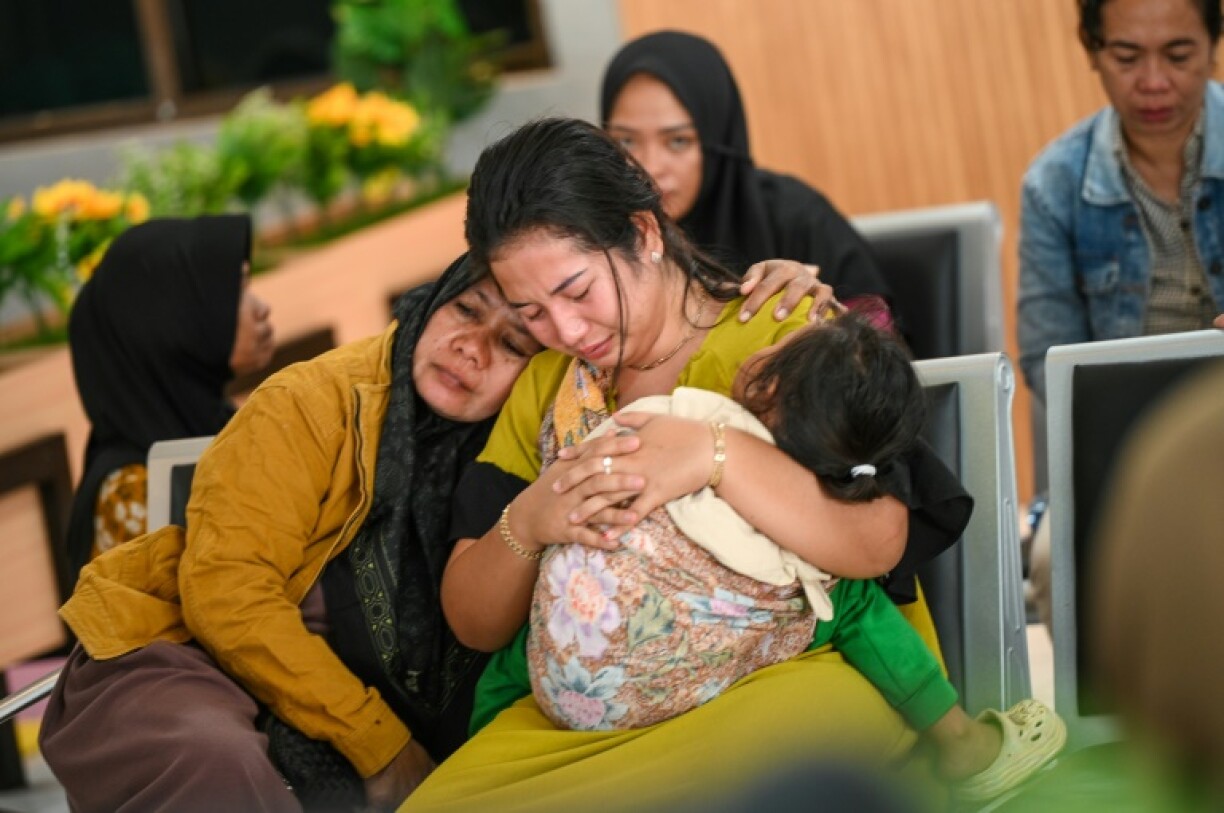 Family members wait at Ketapang Port in East Java for updates on the search for missing people after a ferry sank on its way to the popular Indonesian resort island of Bali