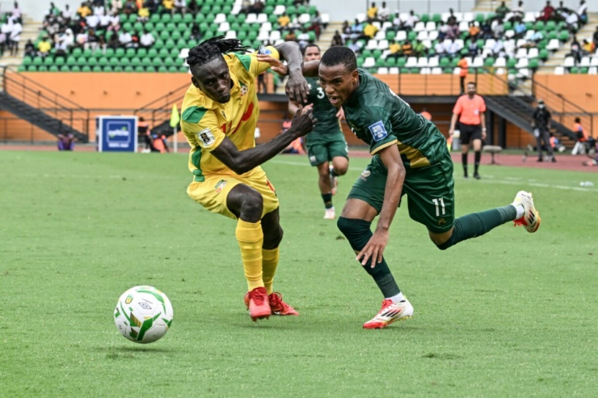 South Africa forward Relebohile Mofokeng (R) fights for the ball with Benin defender Abdoul Moumini during a World Cup qualifier in Abidjan.