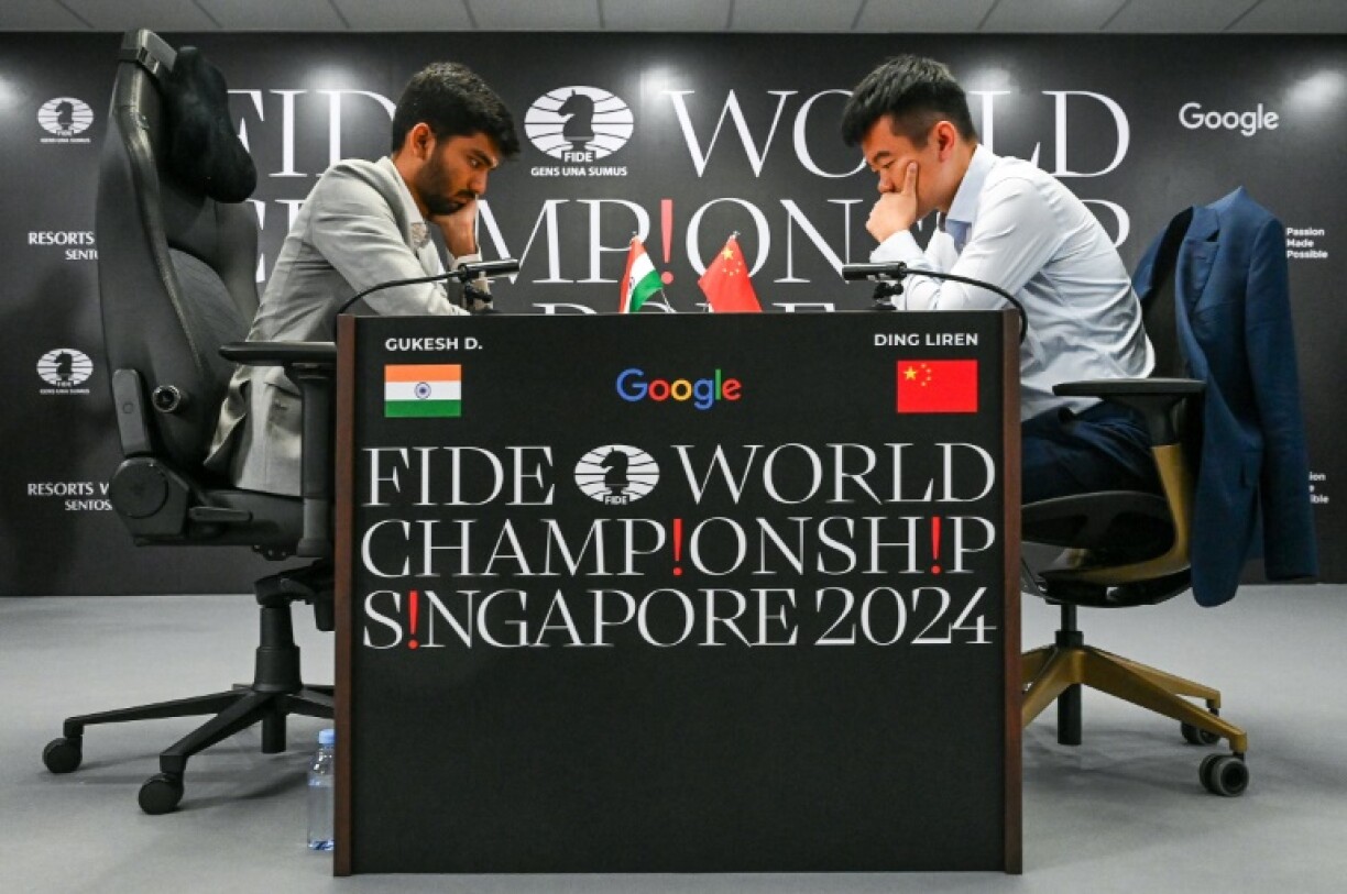 China's chess grandmaster Ding Liren (R) and Indian grandmaster Gukesh Dommaraju are tied at five points each after 10 games in the World Chess Championship