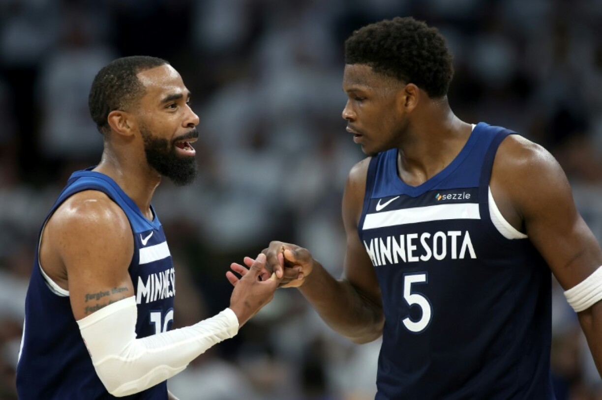 Minnesota's Mike Conley (left) and Anthony Edwards (right) celebrate on their way to a series-clinching victory over the Golden State Warriors
