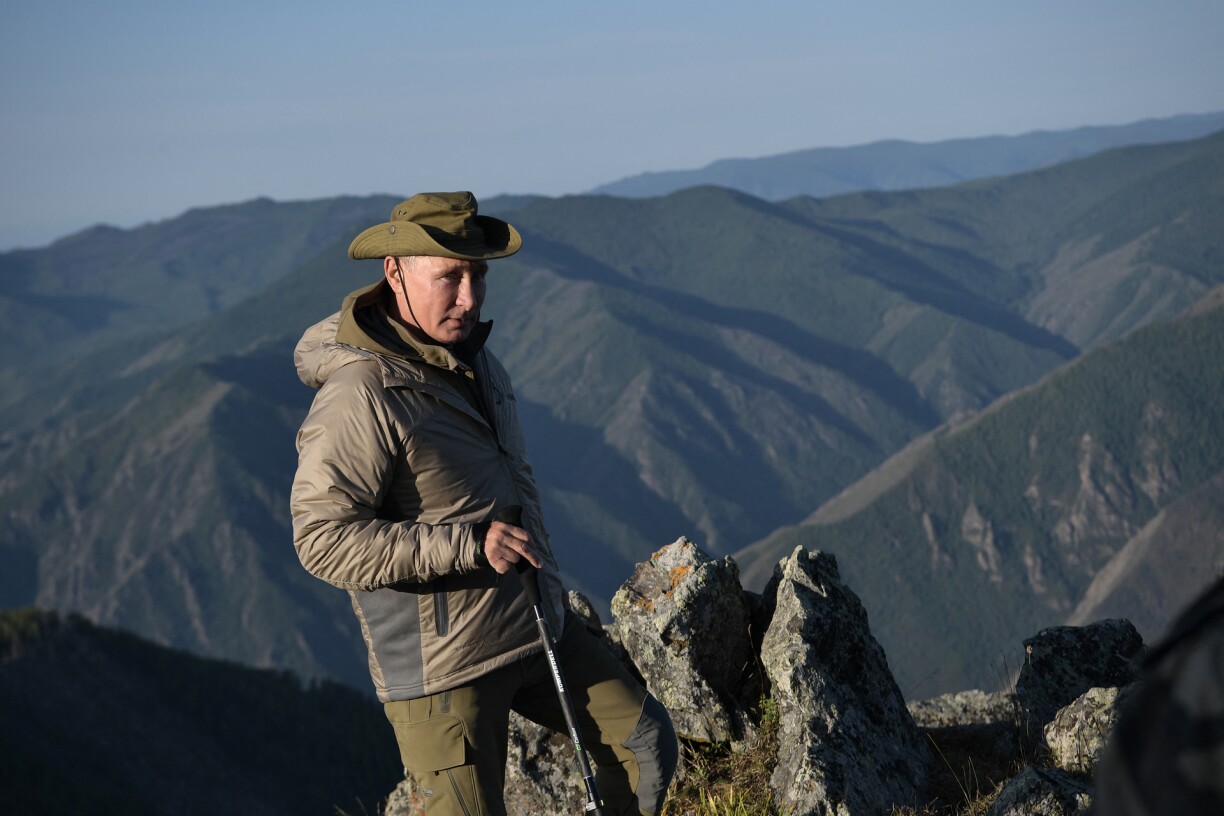 File picture of Russian president Vladimir Putin walking on a mountain.