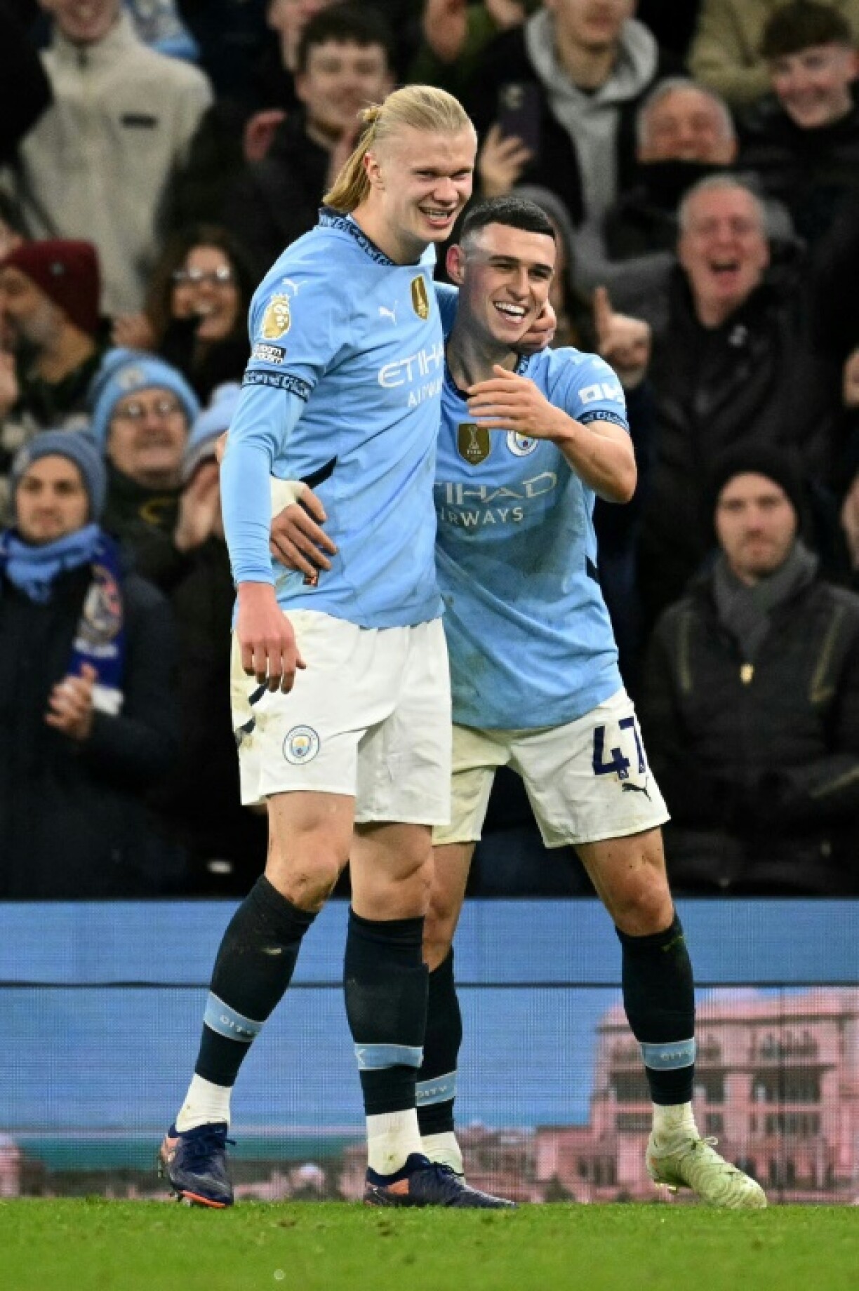 Manchester City's Phil Foden (R) celebrates with Erling Haaland after scoring his team's third goal in the win over Chelsea