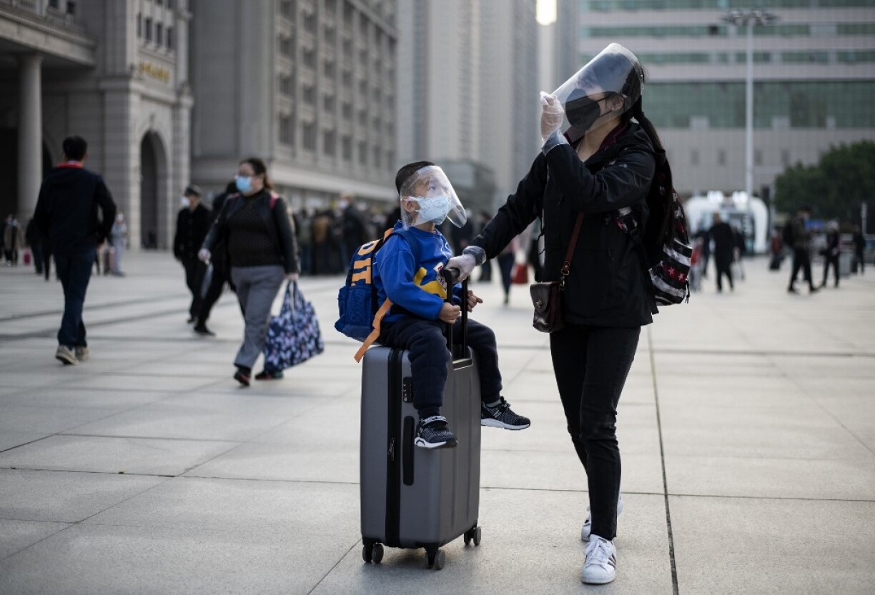 Des voyageurs près de la gare de Wuhan pour accéder aux premiers trains quittant la ville.