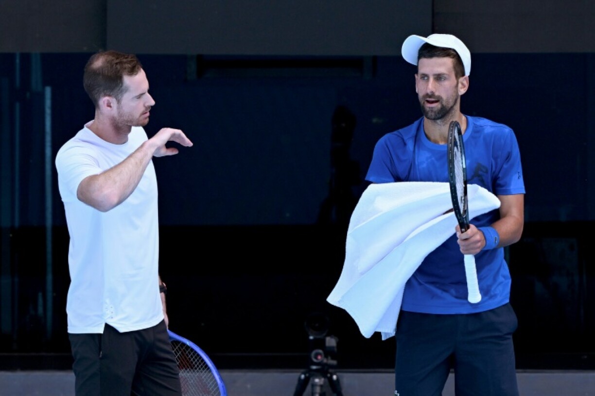 Serbia's Novak Djokovic (R) listens to coach Andy Murray during a training session ahead of the Australian Open