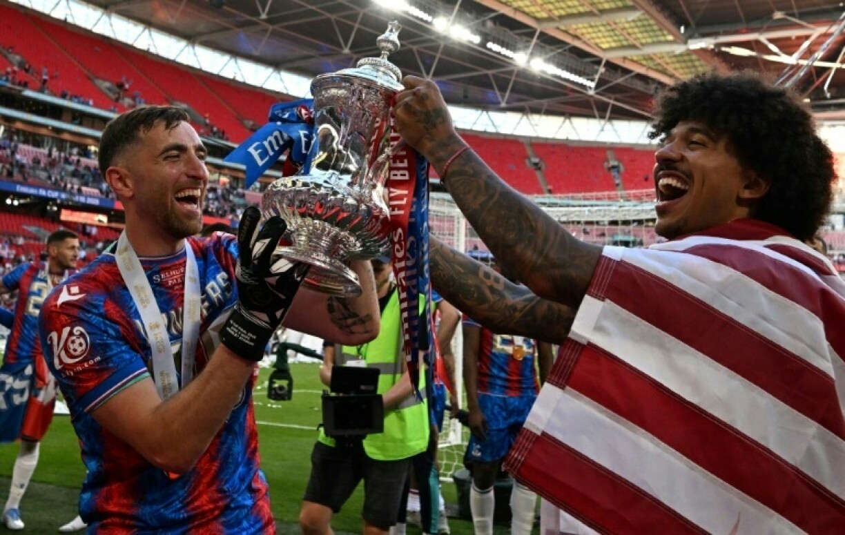 Goalkeeper Matt Turner (L) and defender Chris Richards (R) after helping Crystal Palace win their first major trophy in the English FA Cup final at Wembley stadium in London on May 17, 2025