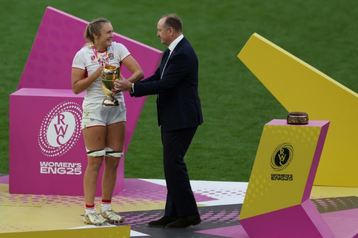 England captain Zoe Aldcroft receives the Women's Rugby World Cup trophy after her side's 33-13 win over Canada in the final at Twickenham