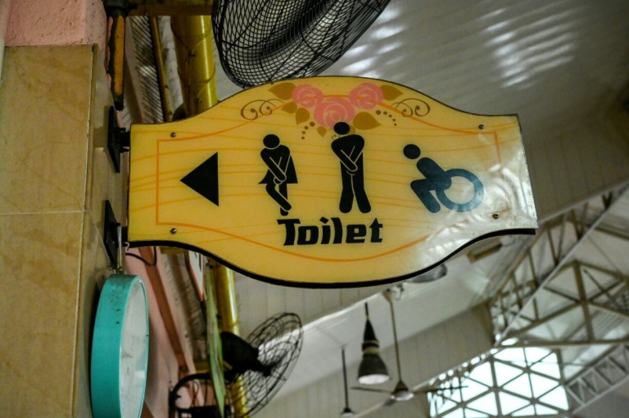 A sign shows directions to a public toilet at a food court in Singapore