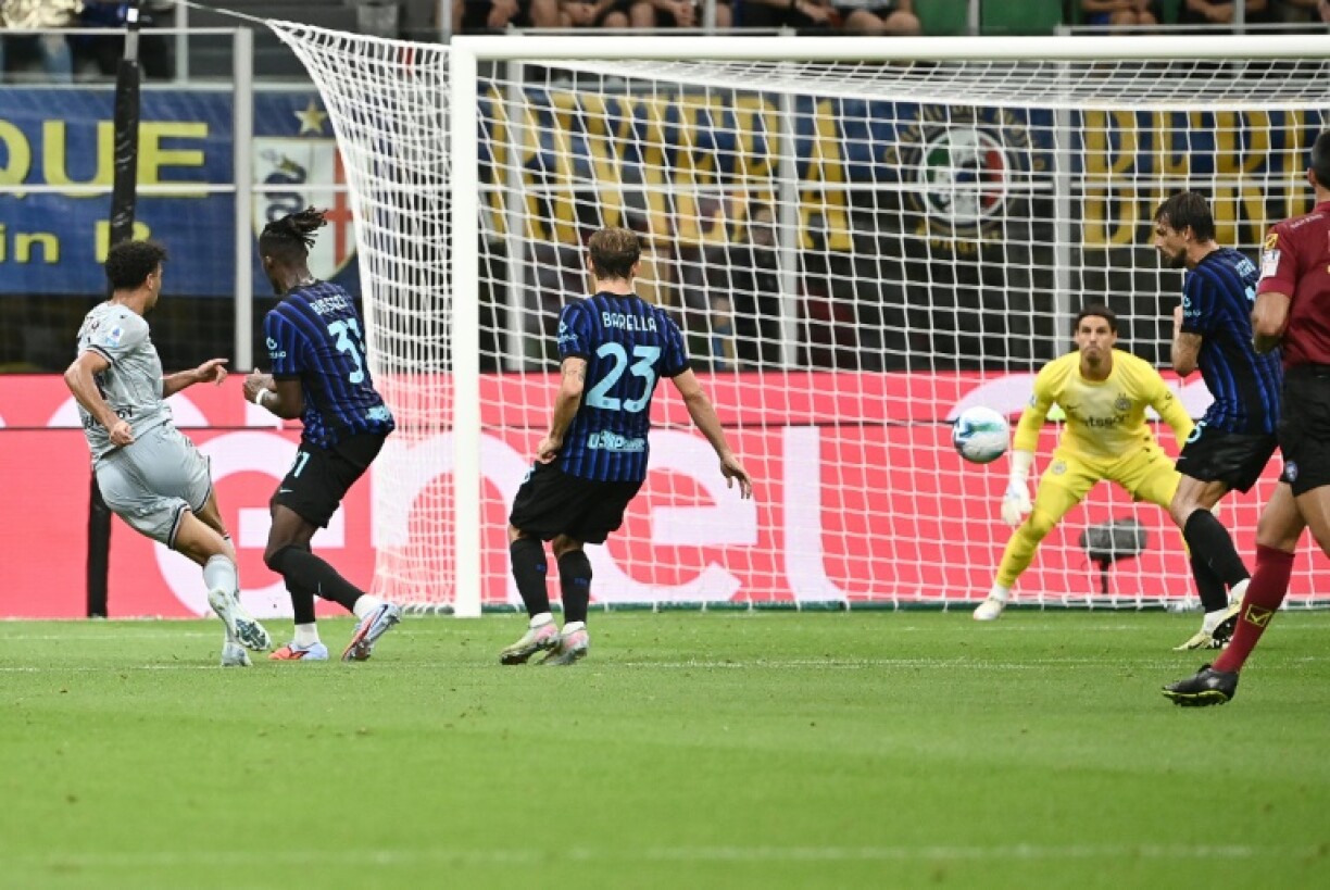 Arthur Atta (L) shoots home Udinese's winning goal against Inter Milan at the San Siro