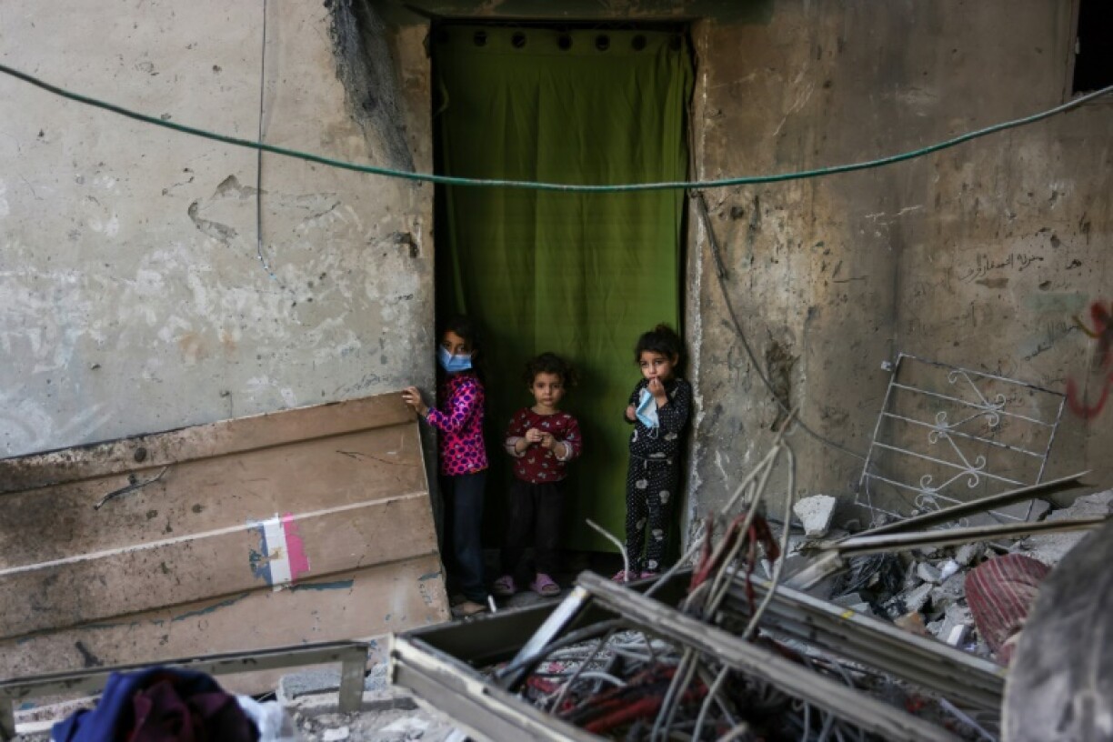 Palestinian children check the site of an Israeli strike in Jabalia