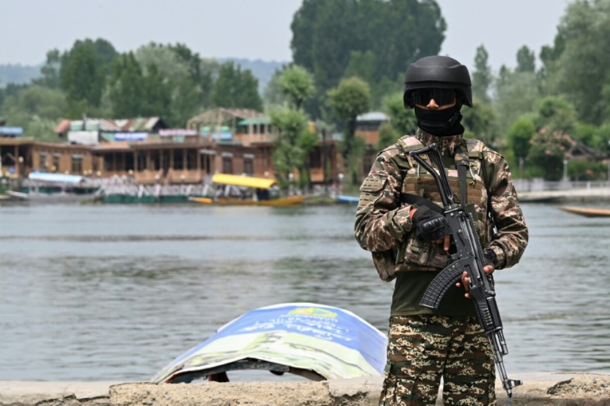 An Indian paramilitary personnel stands guard in Srinagar
