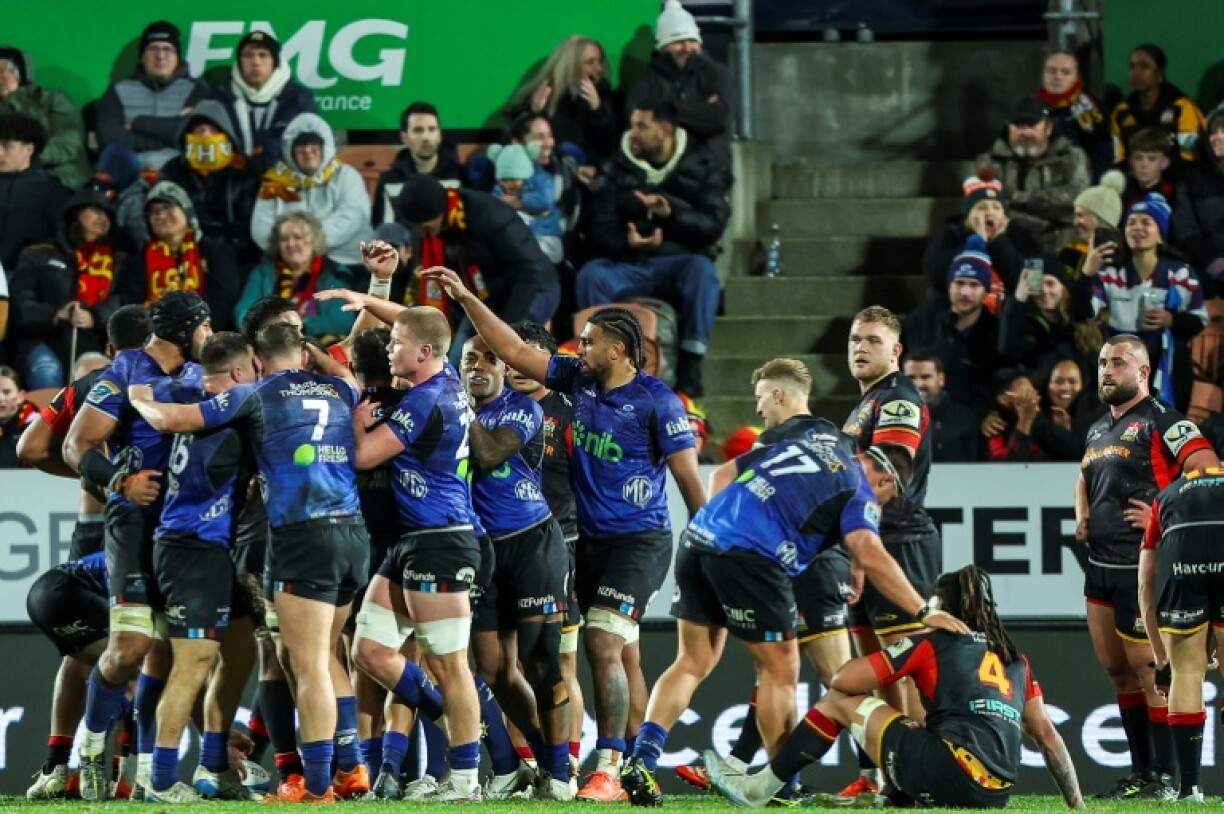 Auckland Blues players celebrate after beating the Waikato Chiefs