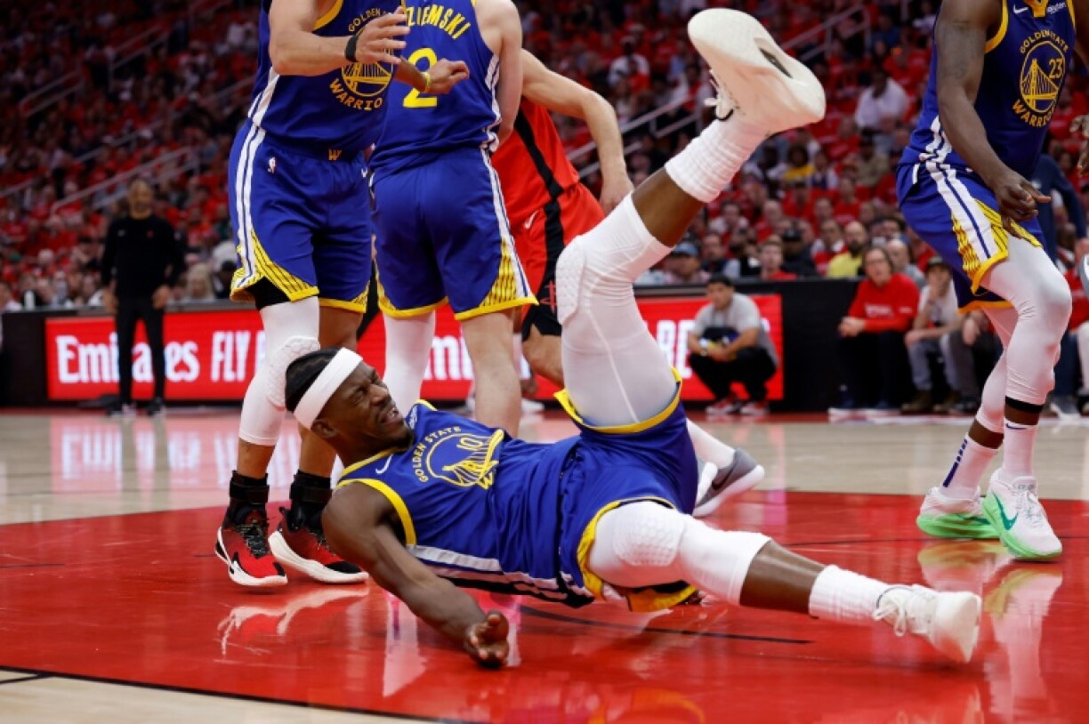 Jimmy Butler of the Golden State Warriors goes down hard after being fouled by Ame Thompson of the Houston Rockets in game two of their NBA playoff series