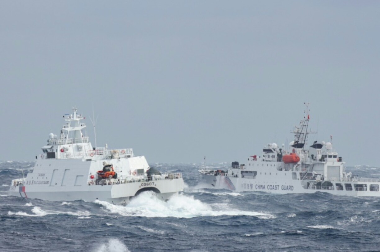 A Taiwanese coast guard ship (L) sails near a Chinese vessel a few nautical miles from Taiwan's northeastern coast