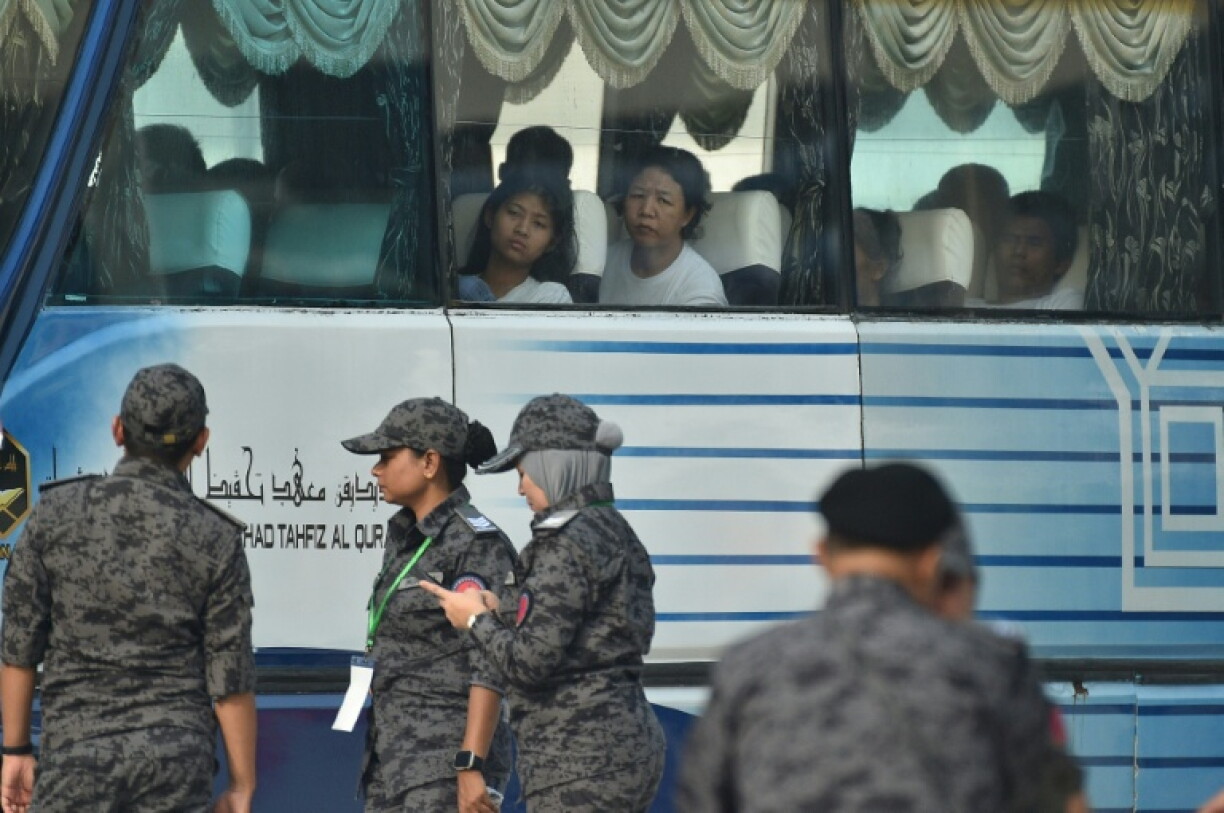 A bus carrying Myanmar nationals being repatriated from Malaysia to their homeland, is seen heading toward to navel base in Lumut, on the outskirts of Kuala Lumpur