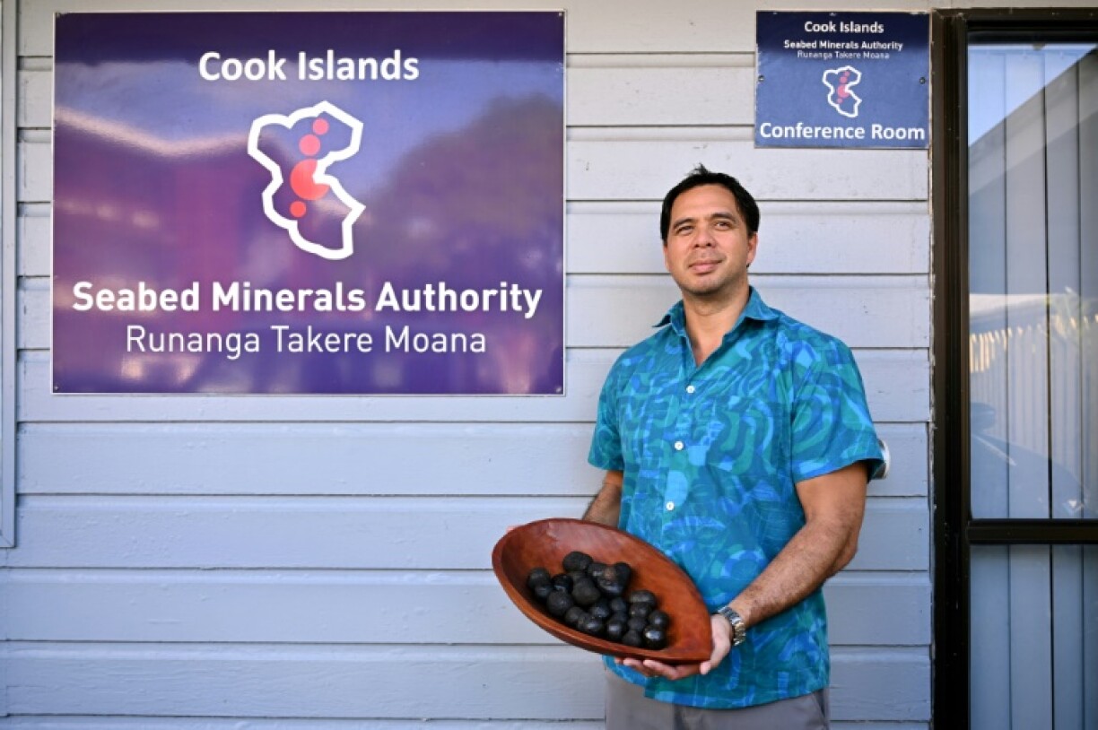 Edward Herman from the Cook Islands' Seabed Minerals Authority holds polymetallic nodules, misshapen black globes encrusted with cobalt, nickel, manganese and other coveted metals in Rarotonga