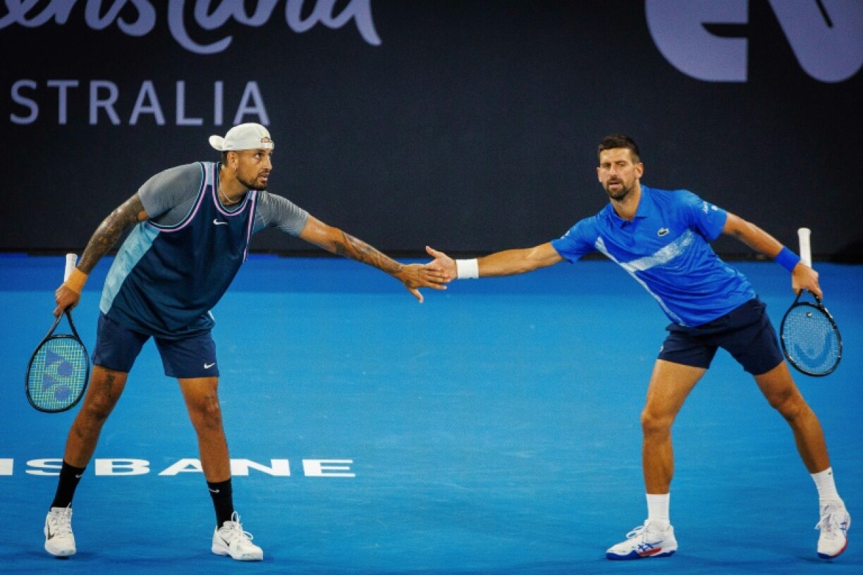 Australia’s Nick Kyrgios (L) and Serbia’s Novak Djokovic (R) lost in the doubles at the Brisbane Interational