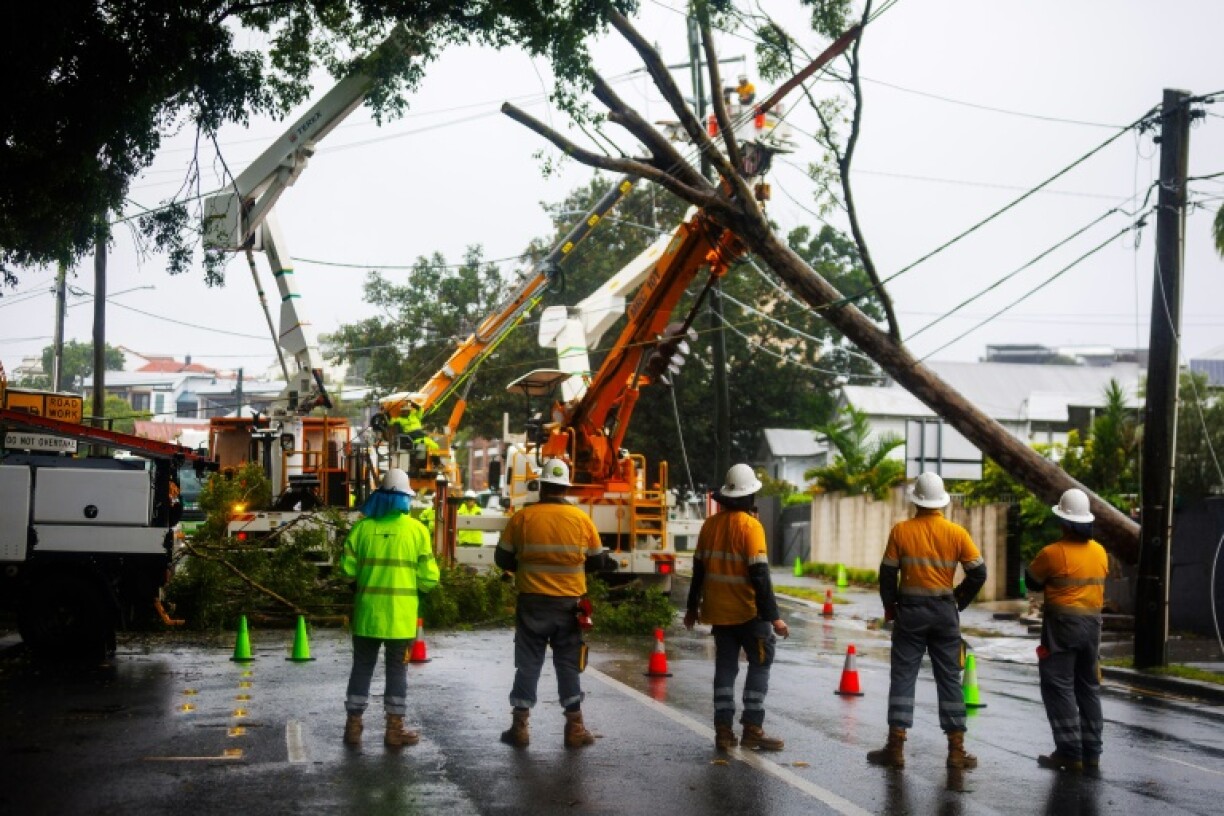 Energex crews clear a fallen tree following the passage of tropical cyclone Alfred in Brisbane on March 8, 2025.