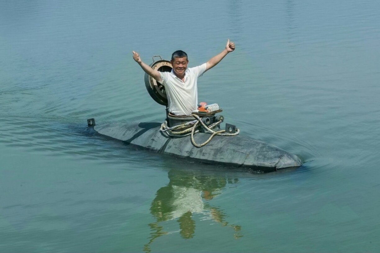 Chinese farmer Zhang Shengwu sits in his homemade submarine in a river in Hanshan county, in China’s eastern Anhui province