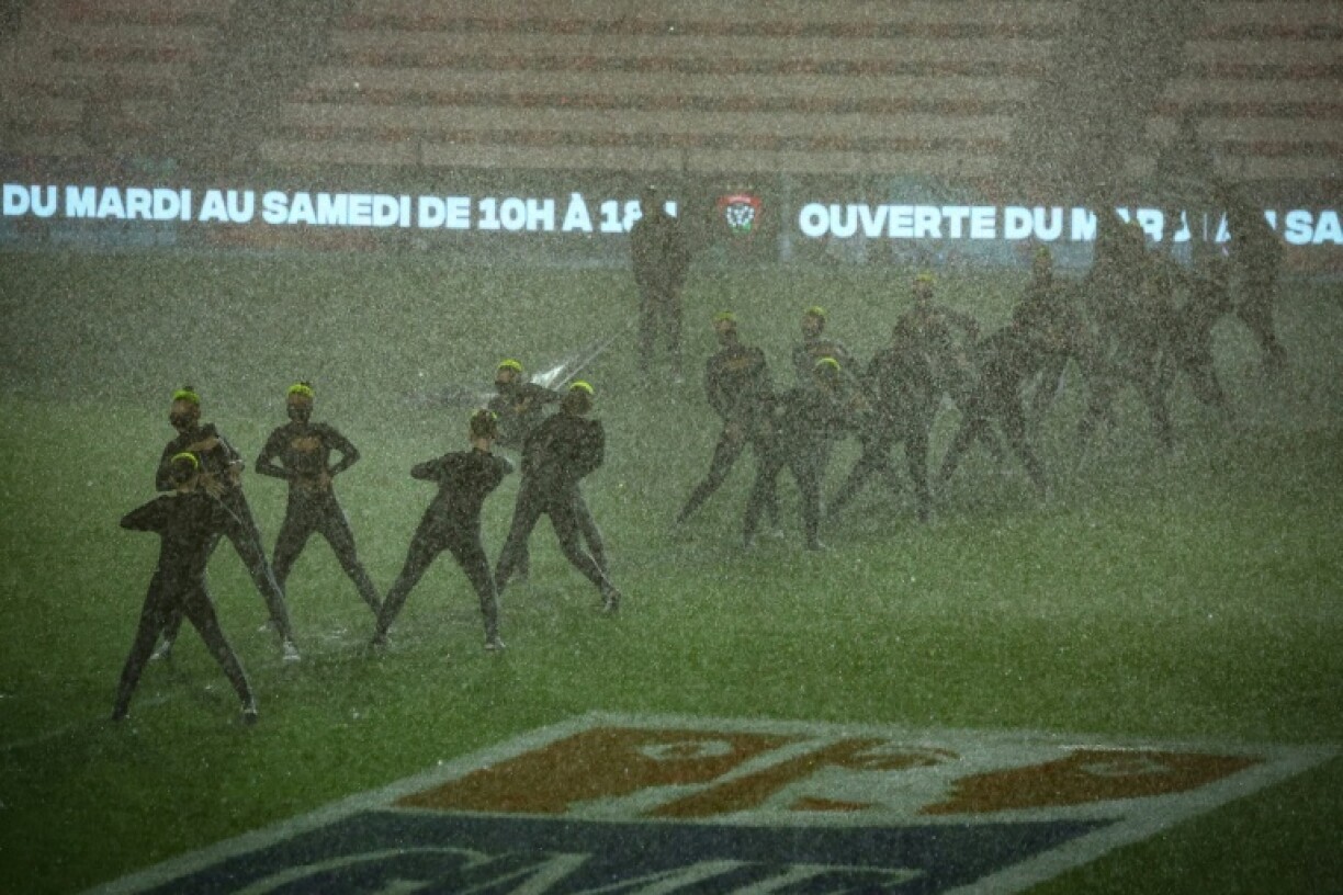 There was a thick layer of water on the pitch, and flooding into the tunnel and changing rooms, but dancers performed in the rain before the French Top 14 match between Toulon and La Rochelle