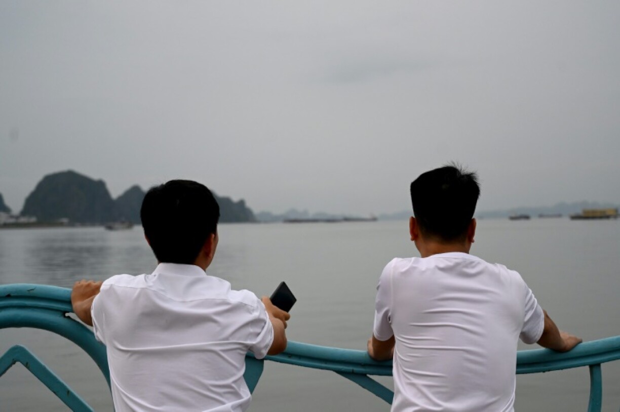 Relatives wait for information about their loved ones after a boat capsized in Vietnam