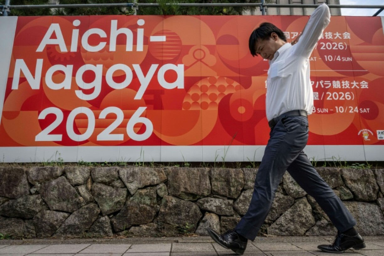 A man walks past an advertisement for the 2026 Asian Games in Nagoya. Organisers are looking to ramp up interest with a year to go until the start of a sporting extravaganza that is bigger than the Olympics