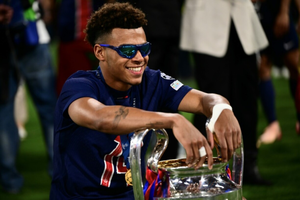 Desire Doue poses with the trophy after starring in Paris Saint-Germain's remarkable Champions League final win over Inter Milan on Saturday