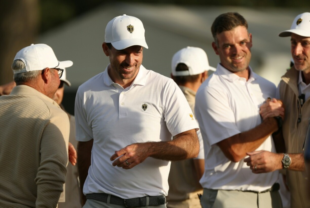 Canada's Nick Taylor and Corey Conners were greeted by teammates after a 1-up victory that gave the Internationals a three-point lead entering the concluding singles matches of the 16th Presidents Cup