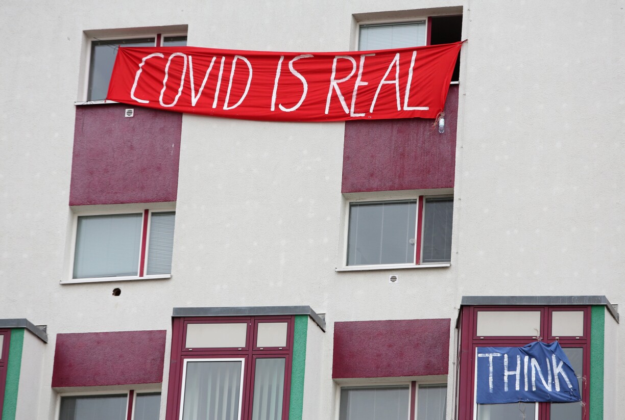 A banner hangs on the windows of an apartment building opposing a demonstration against the measures to curb the spread of the novel coronavirus (COVID-19), in Frankfurt an der Oder, Germany on November 28, 2020.