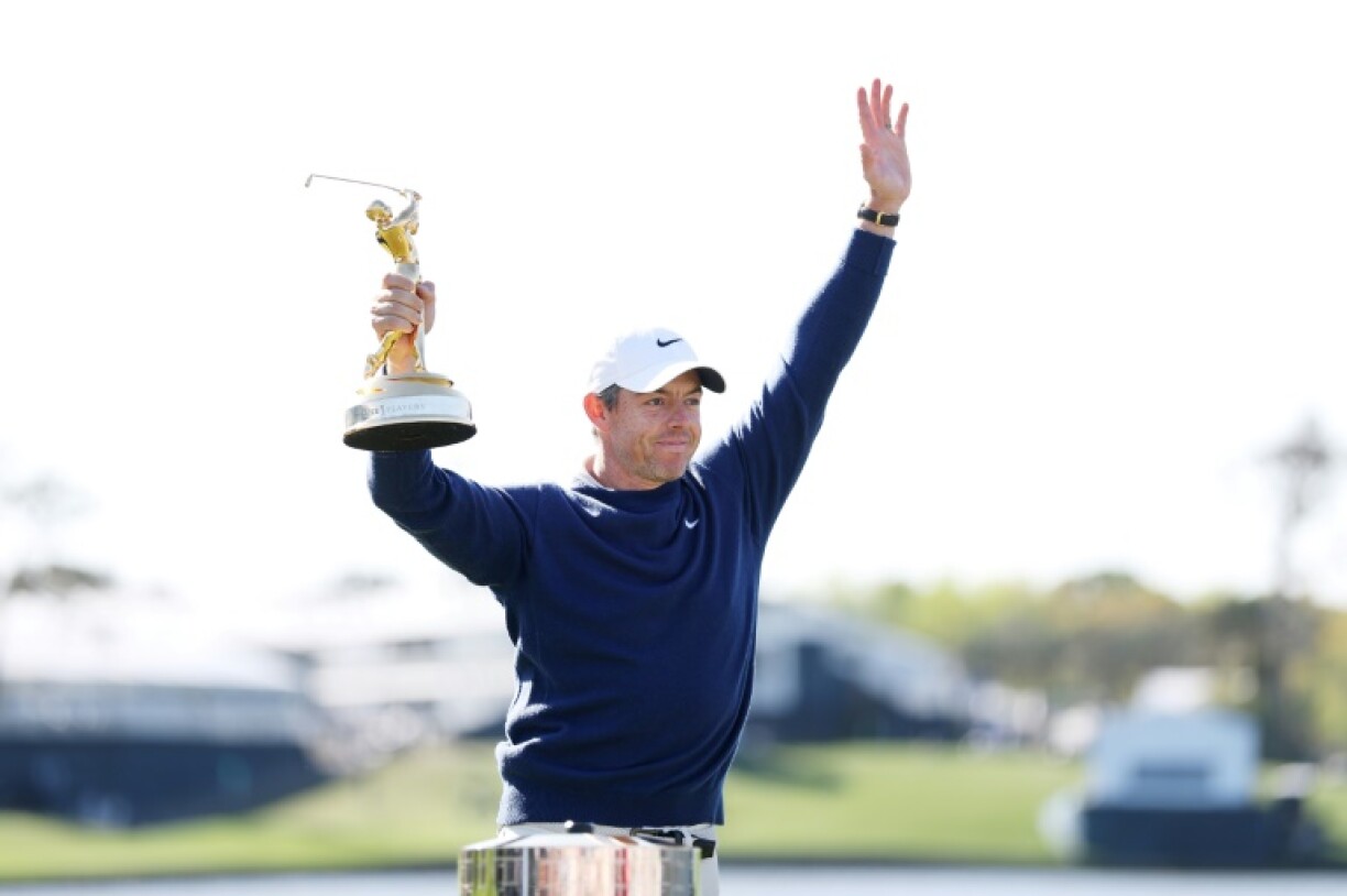 Rory McIlroy celebrates with the trophy after winning the playoff at the Players Championship