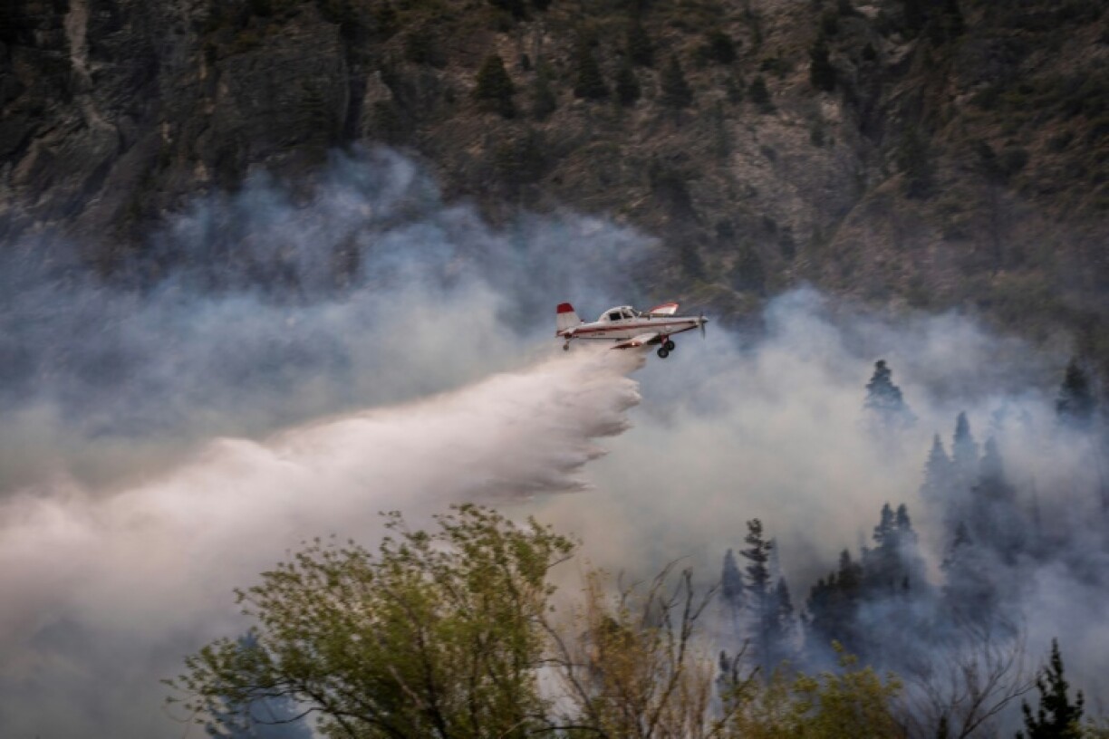 Un avion largue de l'eau sur un feu de forêt au mont Pirque à El Hoyo, dans la province de Chubut, en Patagonie argentine, le 10 janvier 2026