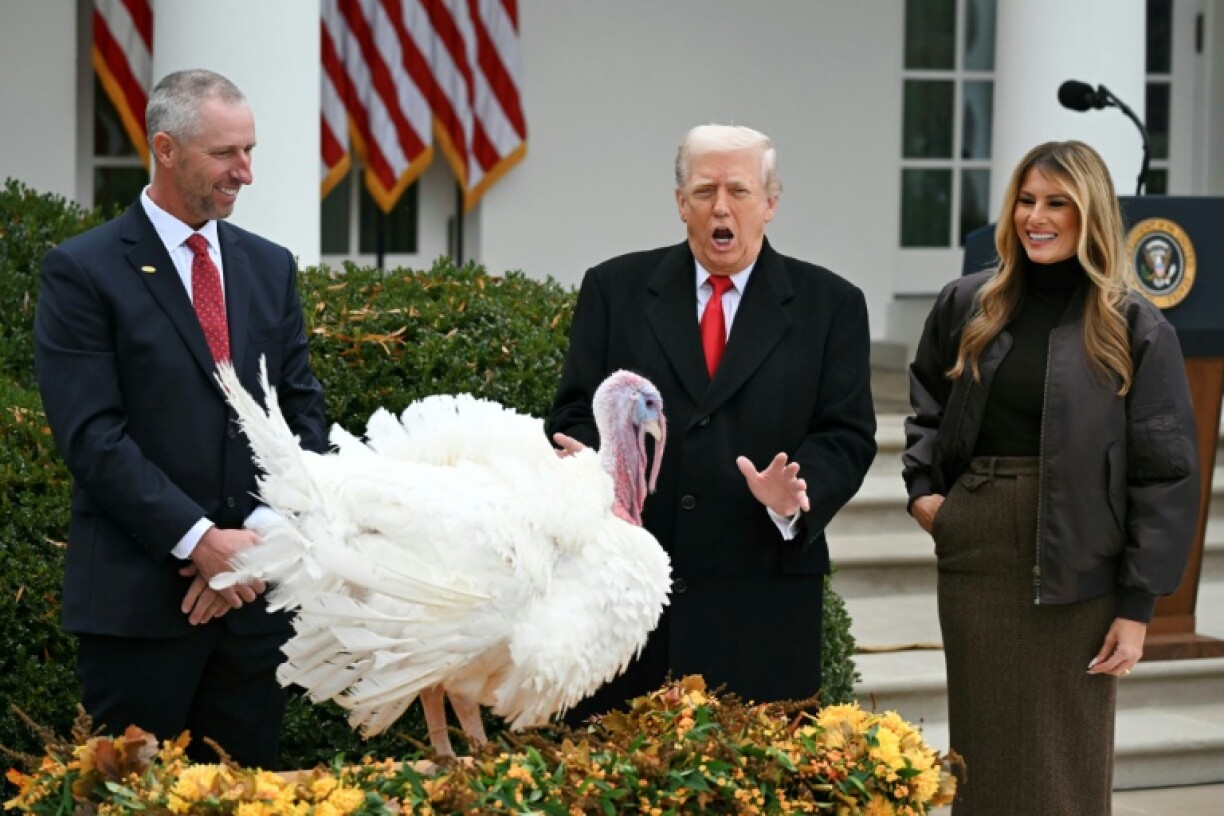 First Lady Melania Trump looks on as US President Donald Trump pardons Gobble, one of the National Thanksgiving turkeys, during a ceremony in the Rose Garden