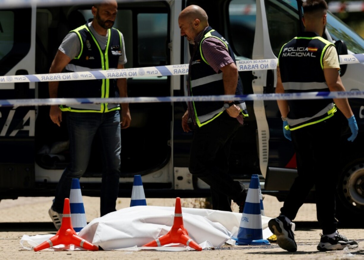 Police officers next to the body of ex-Ukraine MP Andriy Portnov after he was shot dead in Pozuelo de Alarcon, near Madrid