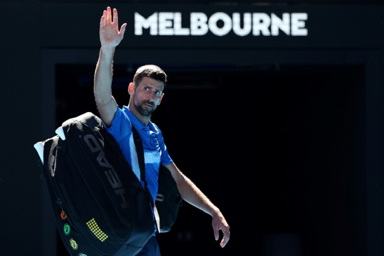 All over: Novak Djokovic exits the court after retiring from the Australian Open semi-final against Alexander Zverev